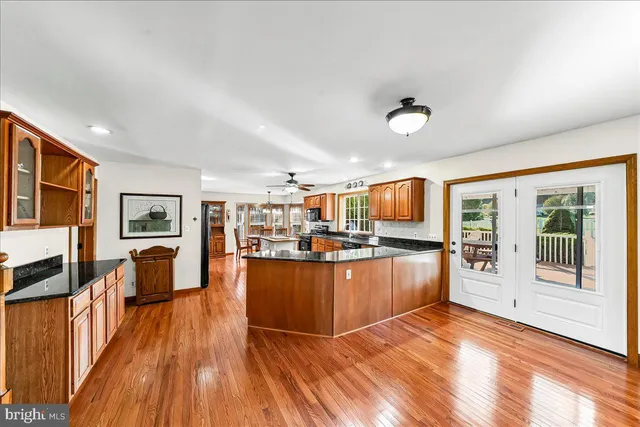 wooden floor fireplace and windows in an empty room