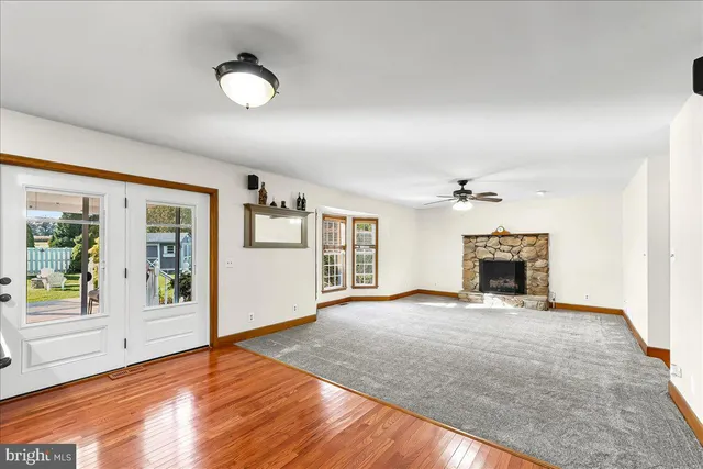 a bathroom with a granite countertop toilet sink and mirror