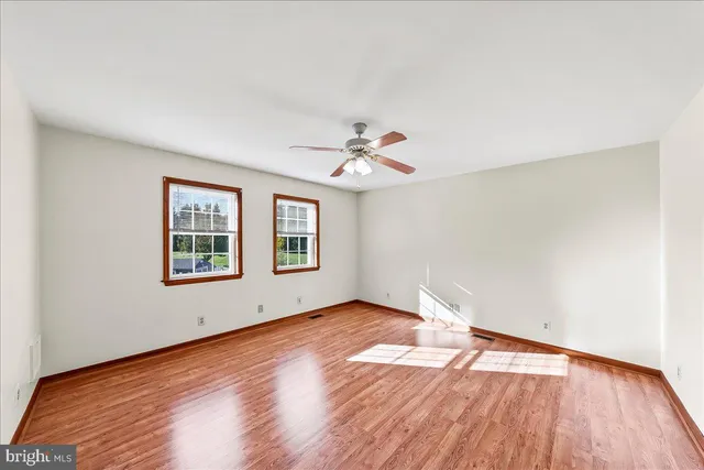 a view of an empty room and wooden floor