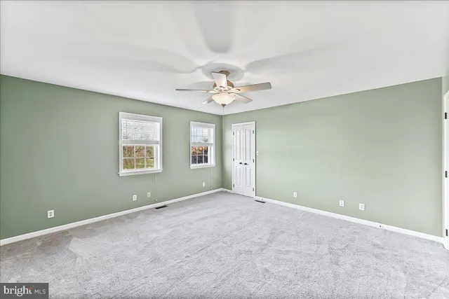 a bathroom with a sink a toilet a mirror and shower curtain