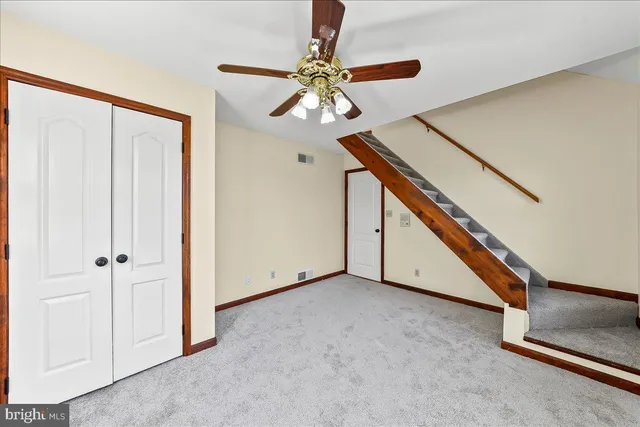 a view of a hallway with wooden floor and stairs