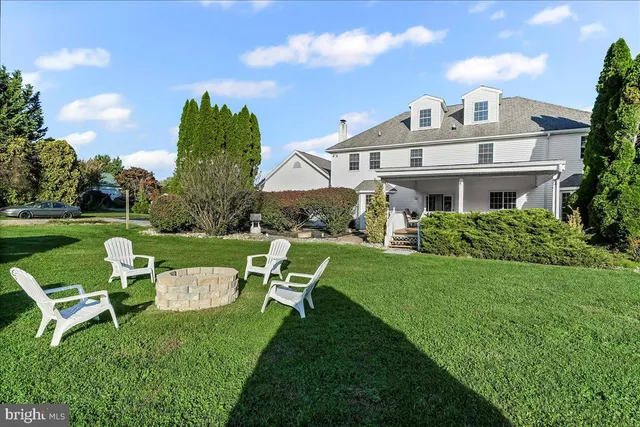 a front view of a house with a yard table and chairs