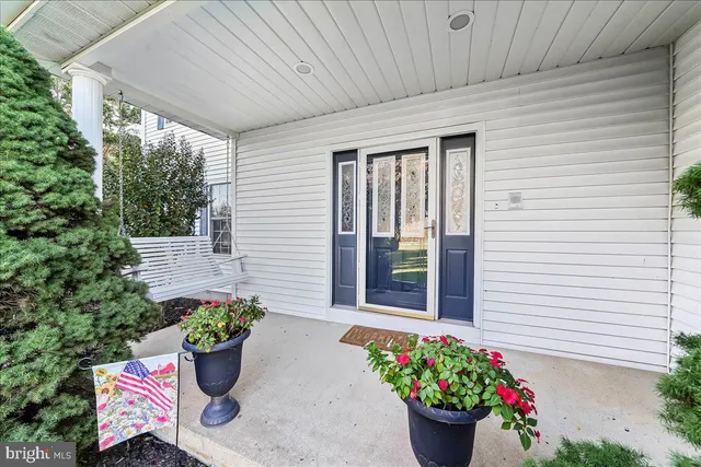 a view of a house with a yard porch and sitting area