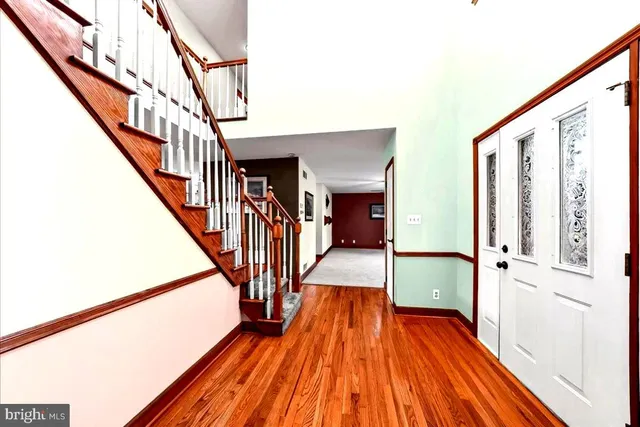 a view of an entryway with wooden floor
