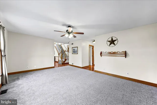 a view of empty room with ceiling fan