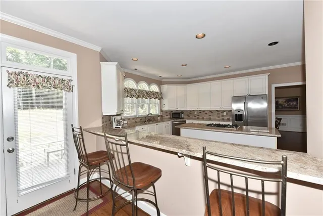 a large kitchen with a table and chairs