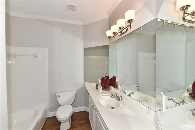 a bathroom with a sink mirror and toilet