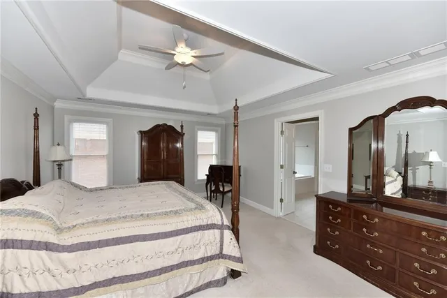 a bedroom with a large bed and a chandelier