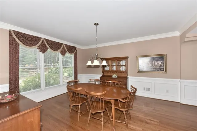 a view of a dining room with furniture window and wooden floor
