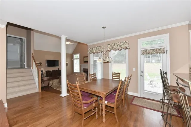 a dining room with furniture window and wooden floor