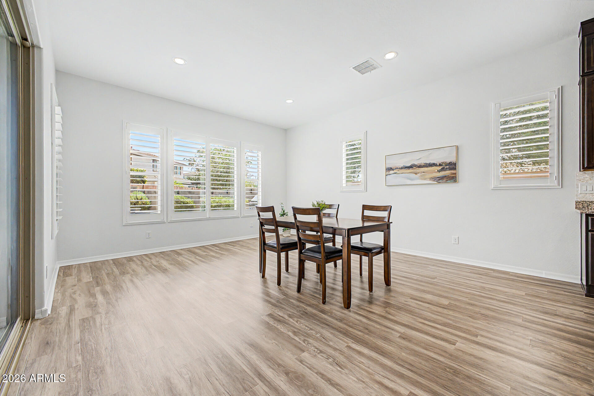 1076 East Kensington Road Gilbert, AZ 85297 - Photo 6 of 73 a view of a dining room with furniture and wooden floor