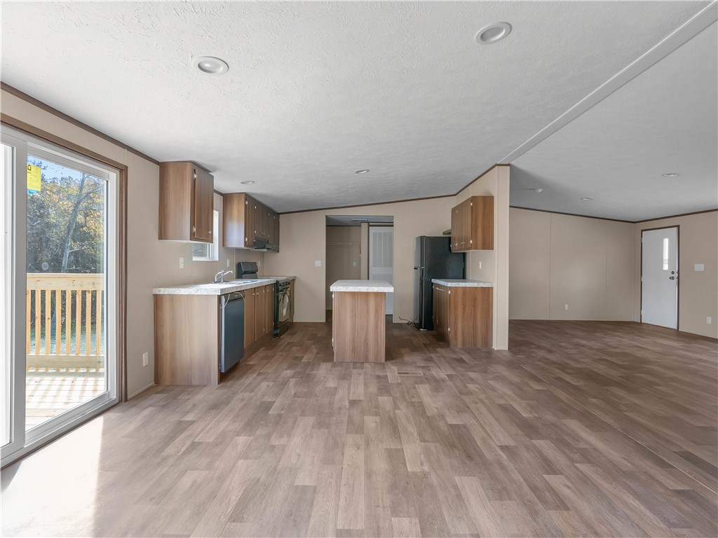 401 Mormon Church Road Seneca, SC 29678 - Photo 11 of 43 This spacious kitchen and living area features sleek flooring, creating an inviting atmosphere for daily living.