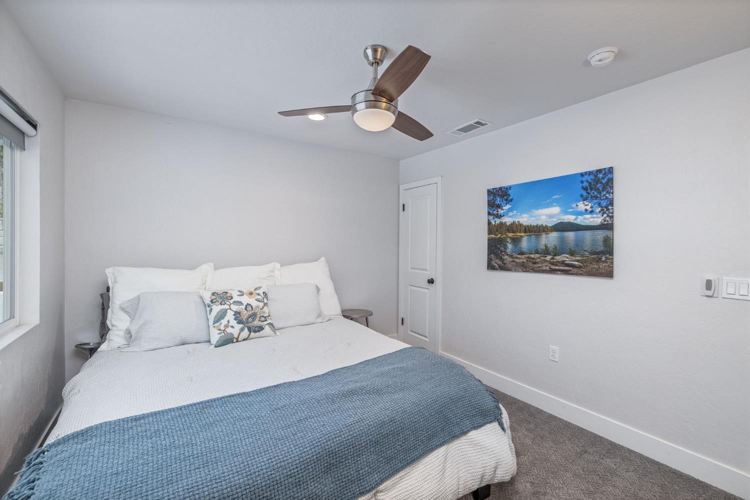 39253 Robin Bass Lake, CA 93604 - Photo 14 of 86 a bedroom with a large bed and a chandelier