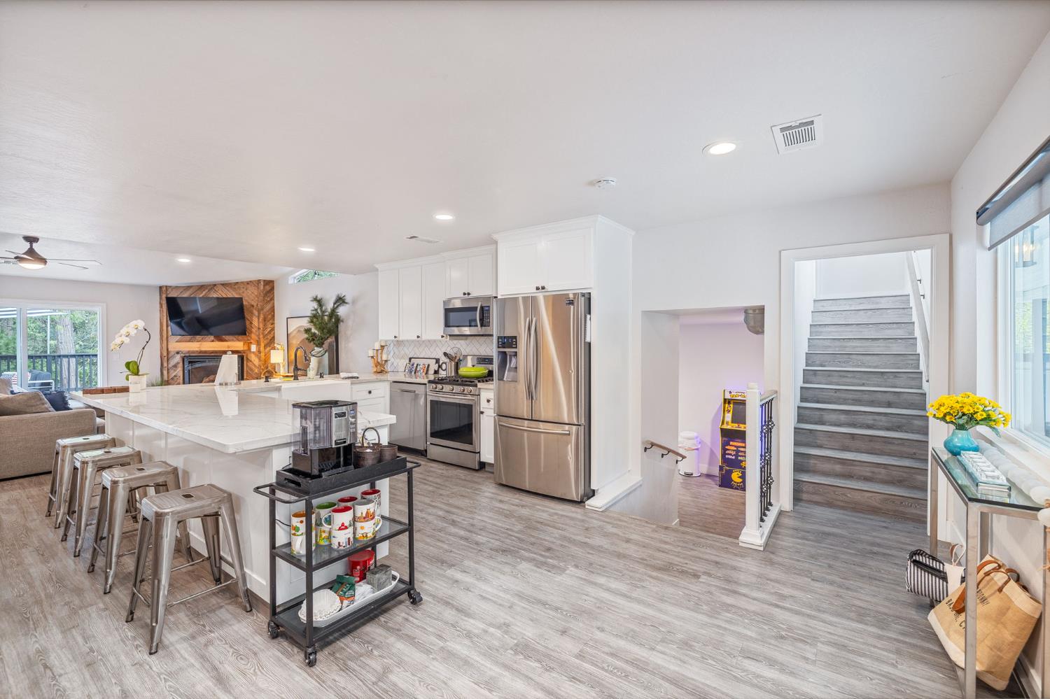 39253 Robin Bass Lake, CA 93604 - Photo 6 of 86 a kitchen with stainless steel appliances kitchen island granite countertop a refrigerator a stove a sink a dining table and chairs with wooden floor