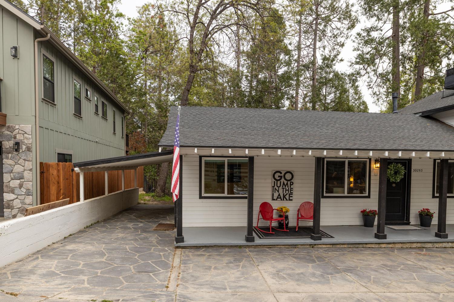 39253 Robin Bass Lake, CA 93604 - Photo 75 of 86 a view of small white house with large windows and a large tree