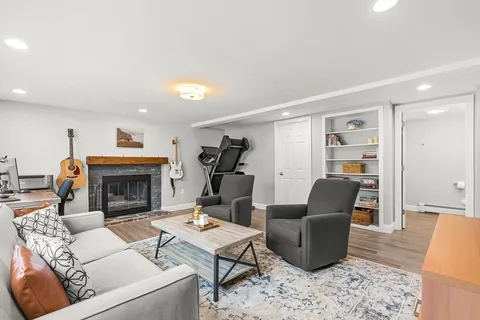 a living room with furniture a fireplace and a table