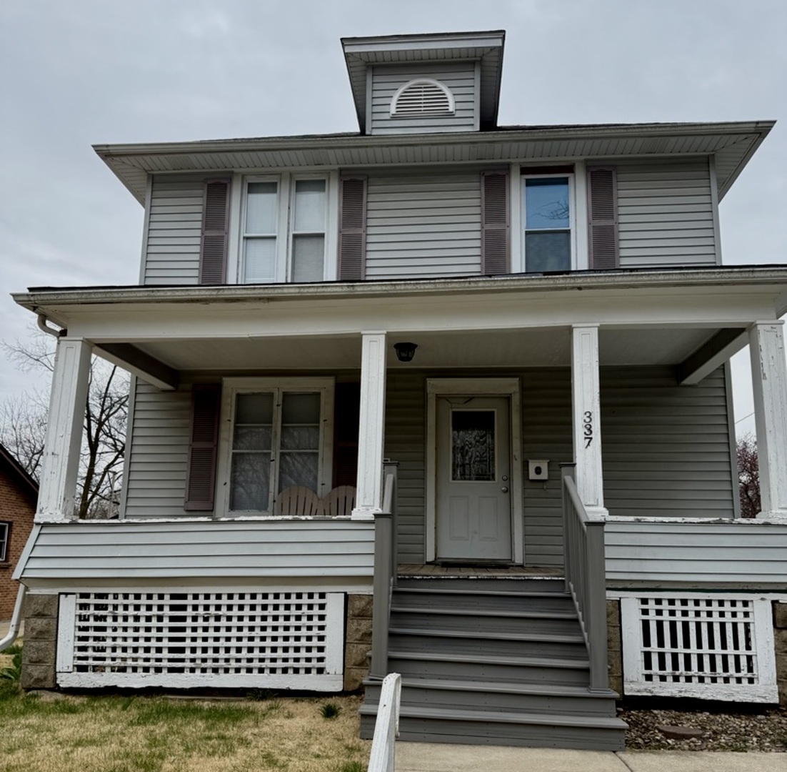 a view of a brick house with large windows
