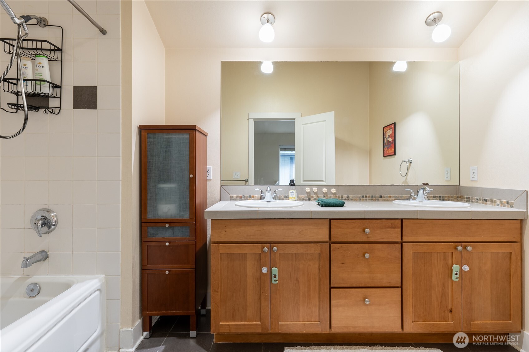 1419 Northwest 65th Street, Unit B Seattle, WA 98117 - Photo 11 of 26 a bathroom with a granite countertop sink a mirror a vanity and bathtub