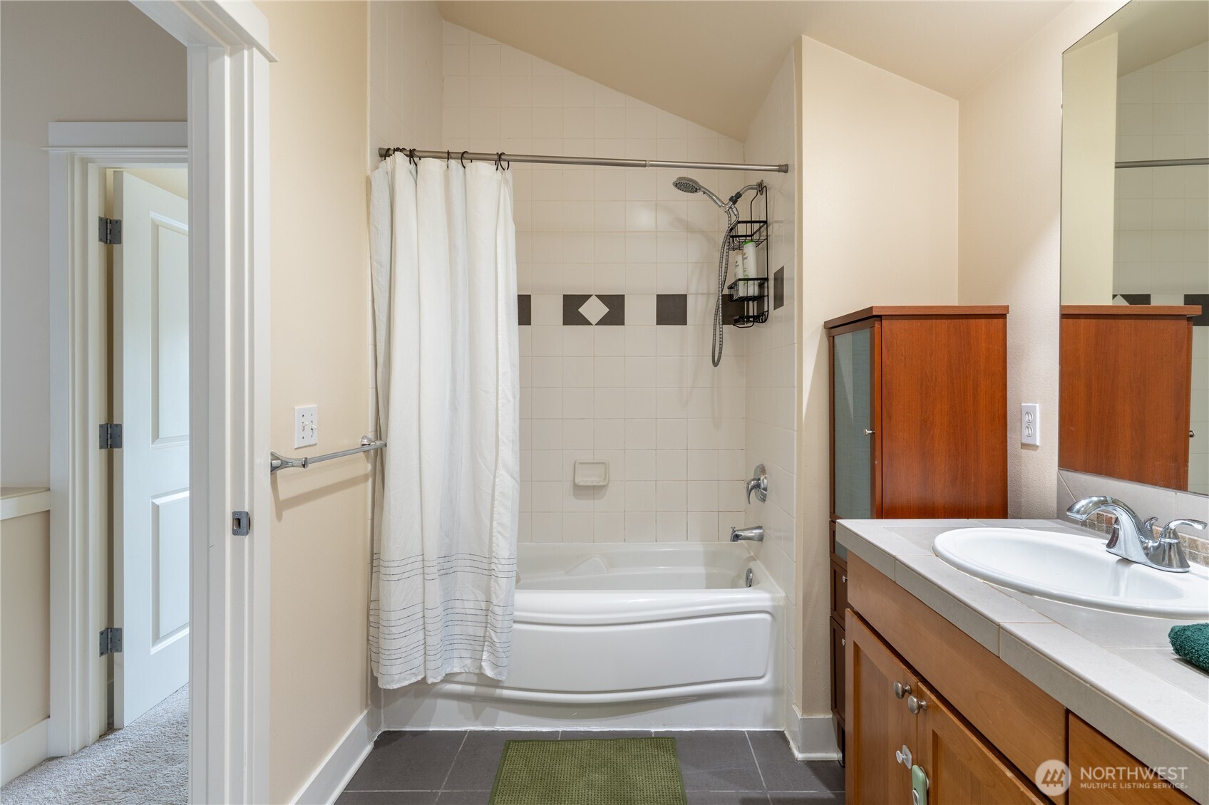 1419 Northwest 65th Street, Unit B Seattle, WA 98117 - Photo 12 of 26 a bathroom with a granite countertop sink toilet and shower