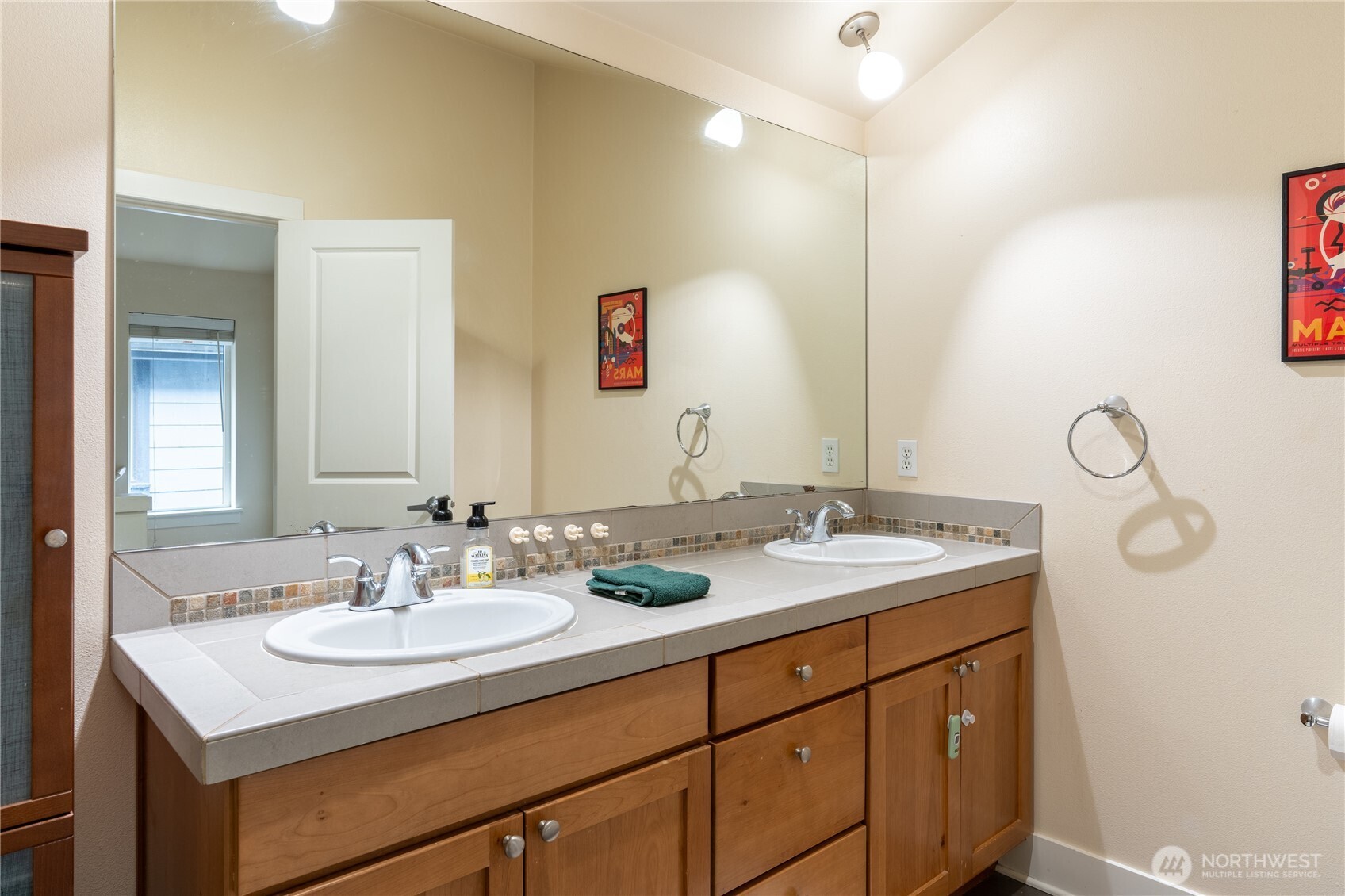 1419 Northwest 65th Street, Unit B Seattle, WA 98117 - Photo 13 of 26 a bathroom with a sink and a mirror
