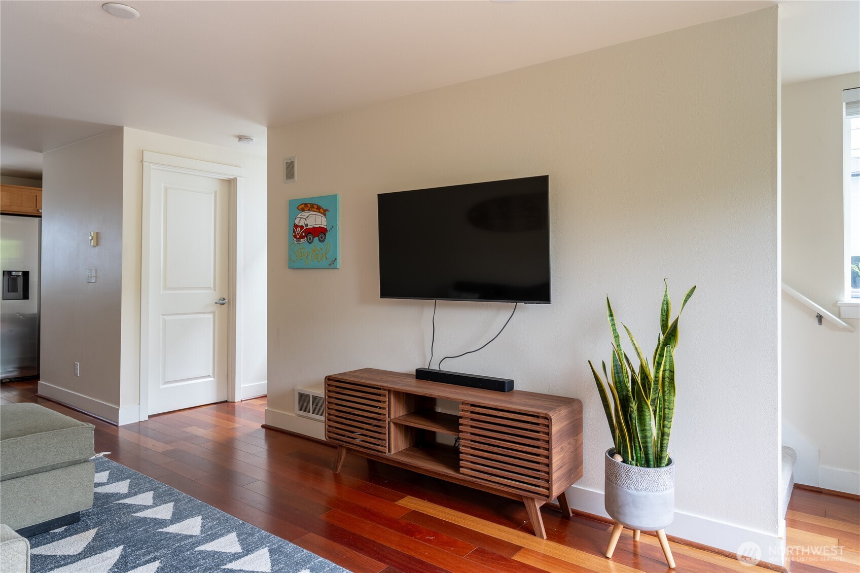 1419 Northwest 65th Street, Unit B Seattle, WA 98117 - Photo 16 of 26 a living room with furniture and a flat screen tv