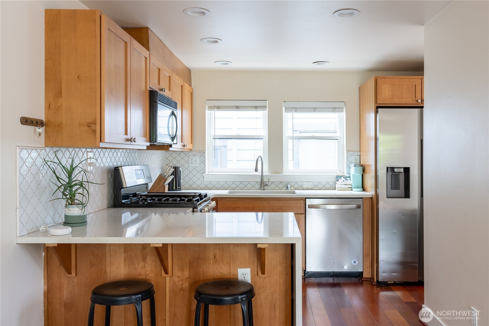 1419 Northwest 65th Street, Unit B Seattle, WA 98117 - Photo 17 of 26 a kitchen with appliances cabinets and a chair