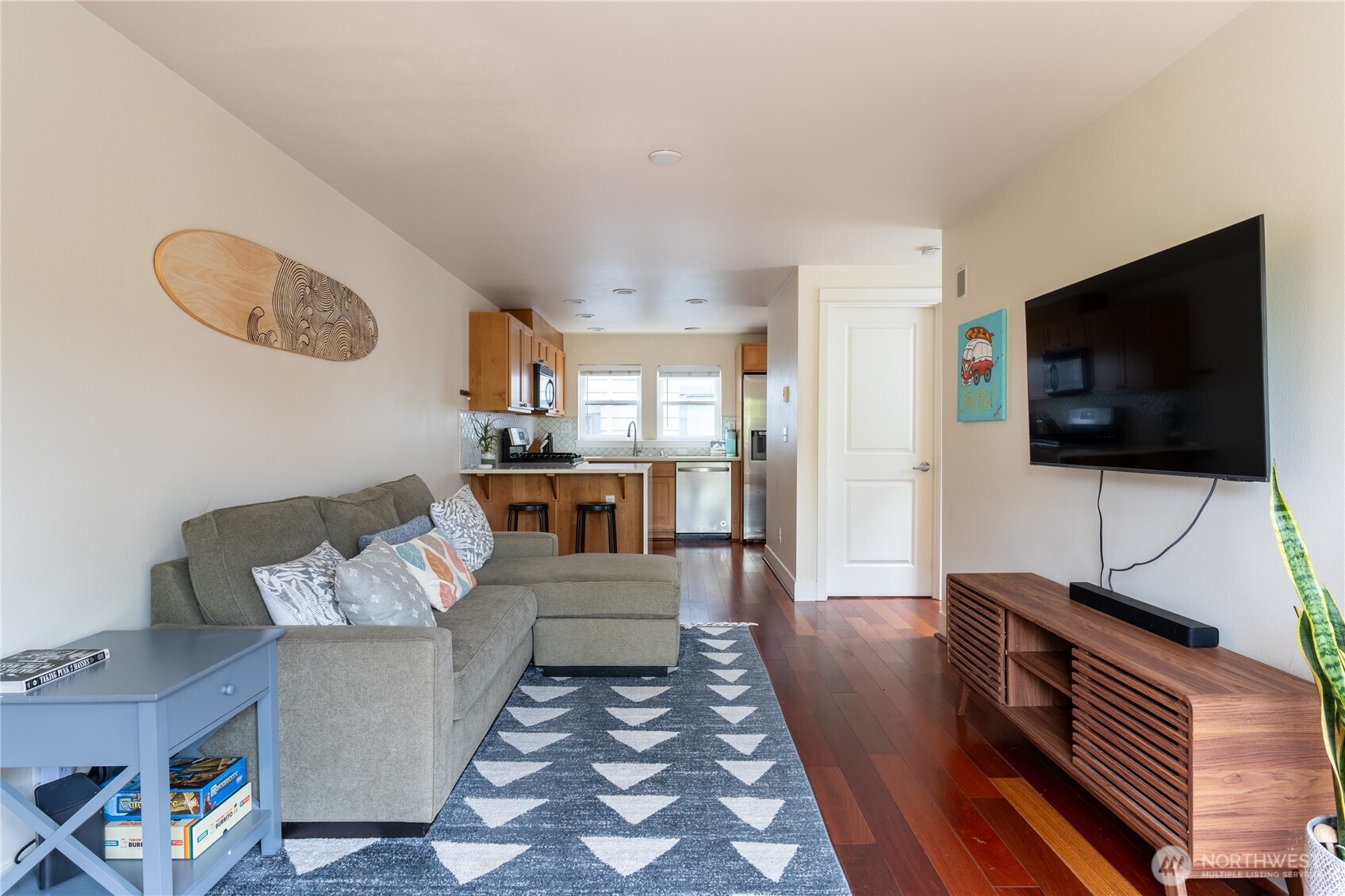 1419 Northwest 65th Street, Unit B Seattle, WA 98117 - Photo 2 of 26 a living room with furniture and a flat screen tv