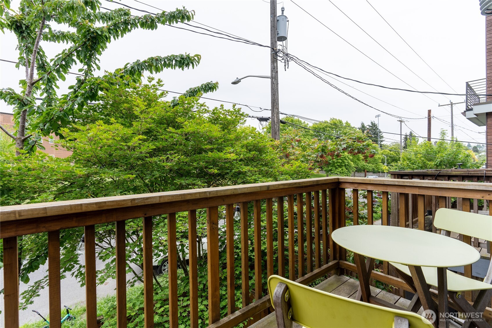 1419 Northwest 65th Street, Unit B Seattle, WA 98117 - Photo 22 of 26 a view of a balcony with table and chairs