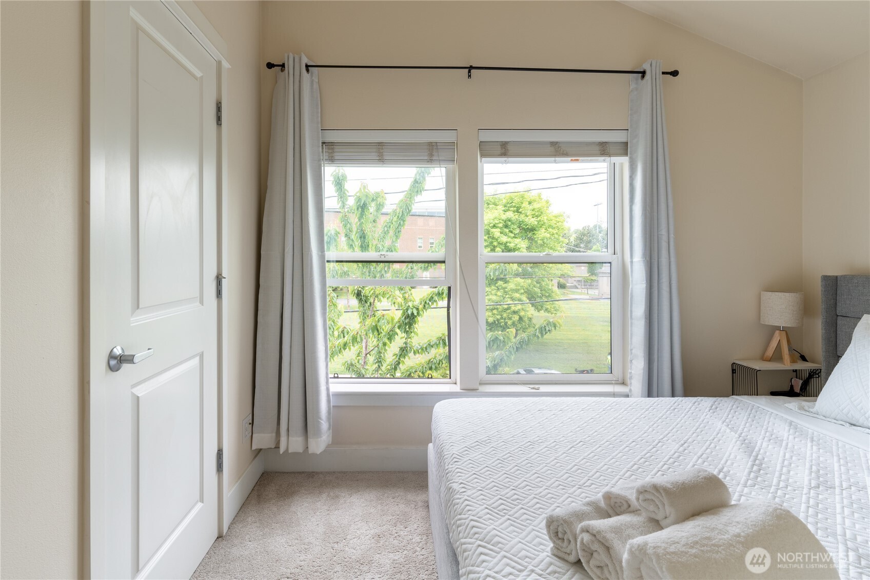 1419 Northwest 65th Street, Unit B Seattle, WA 98117 - Photo 9 of 26 a bedroom with a bed and a window