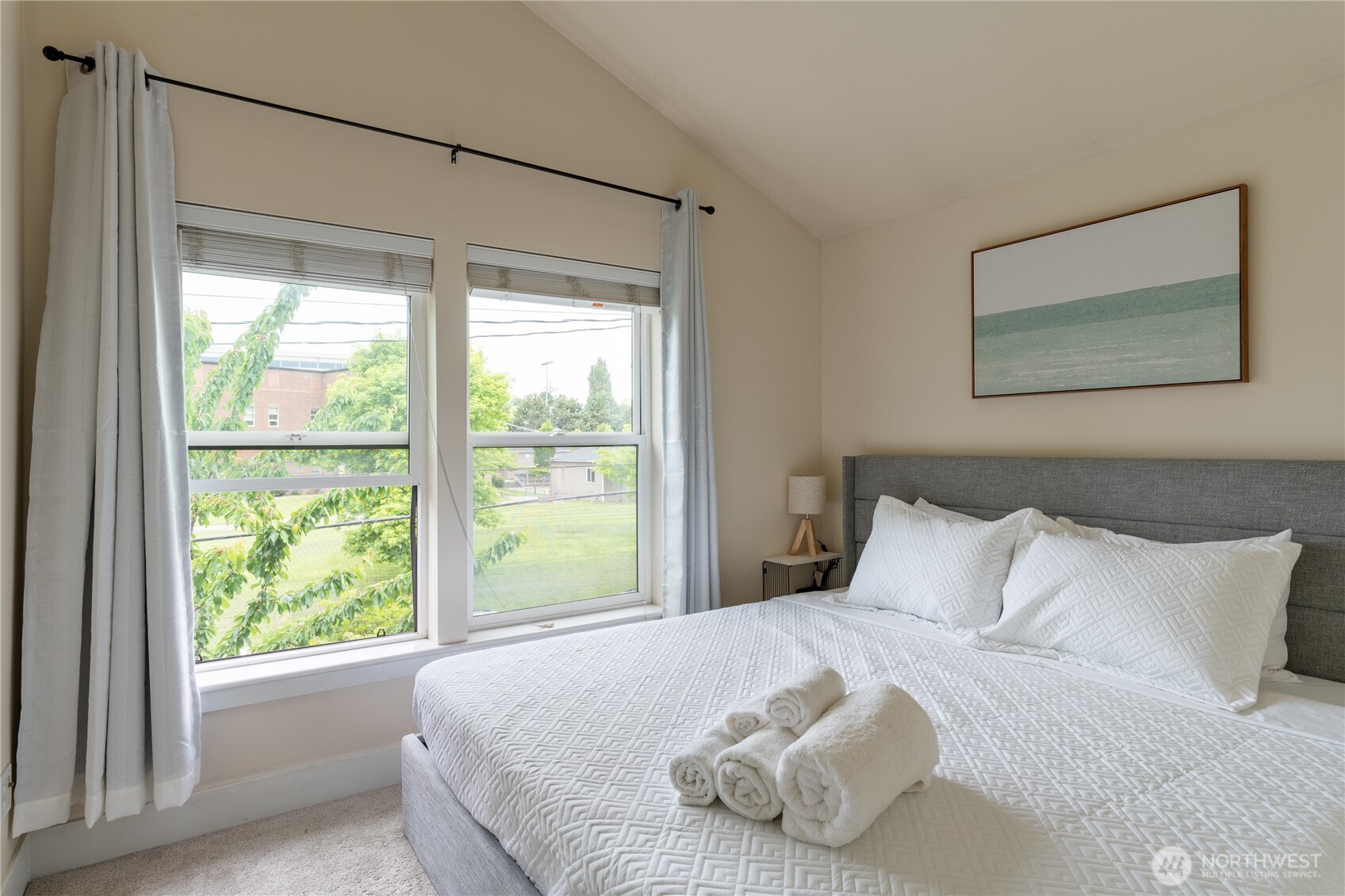 1419 Northwest 65th Street, Unit B Seattle, WA 98117 - Photo 10 of 26 a bedroom with a bed and a window