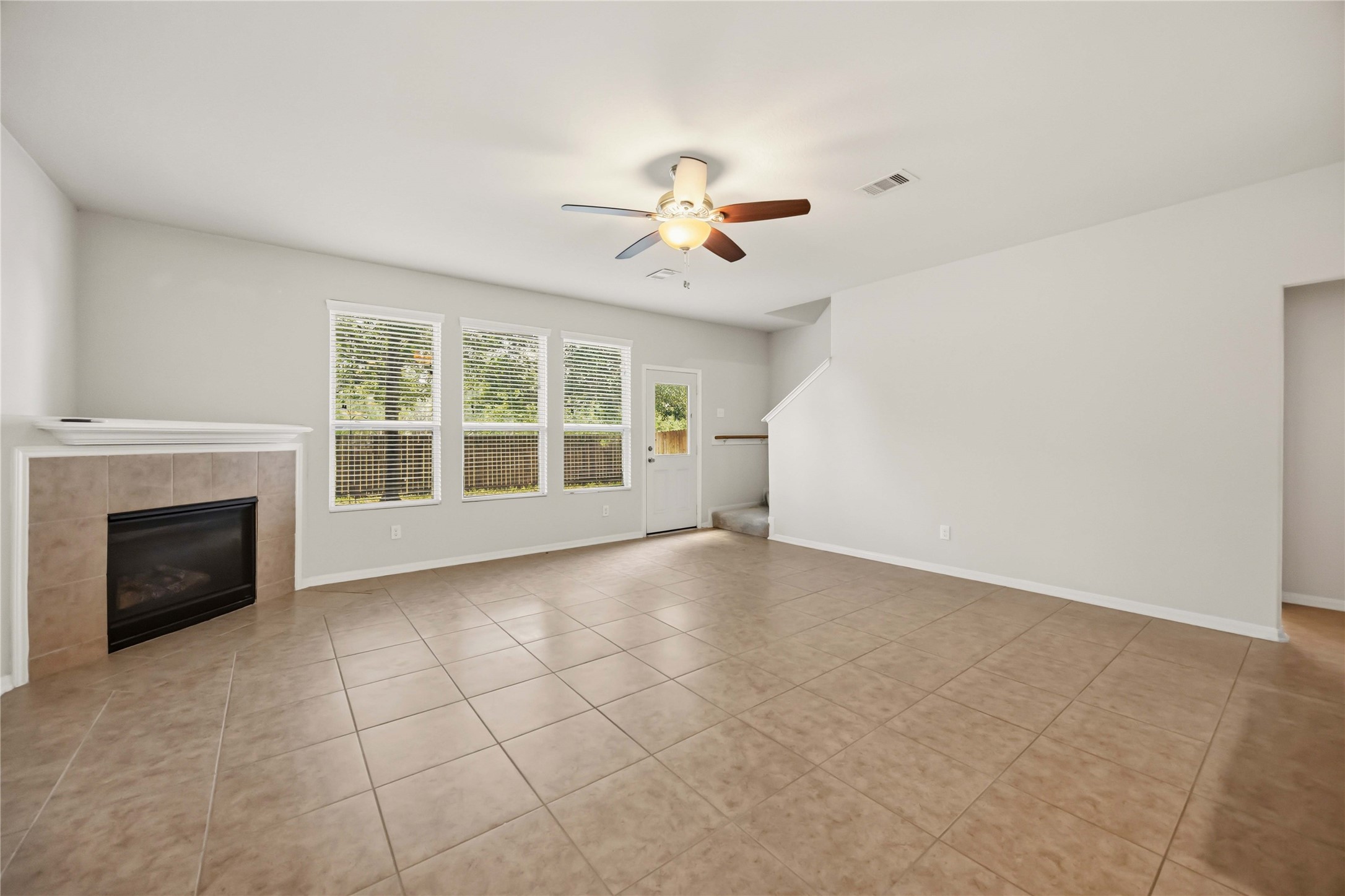 29526 Winton Wood Way Spring, TX 77386 - Photo 4 of 29 Spacious living room featuring abundant natural light, a cozy fireplace, and an open-concept layout.