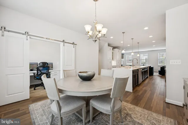a kitchen with cabinets and wooden floors