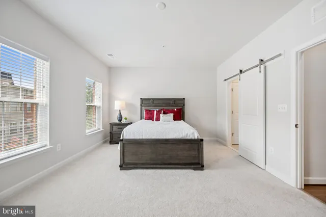 a spacious bedroom with a bed and a book shelf