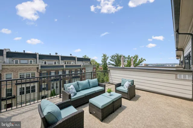 a bathroom with a granite countertop sink mirror vanity and toilet