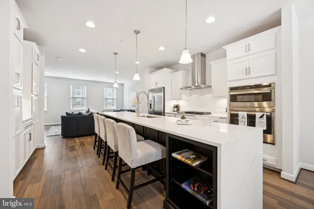 a kitchen with granite countertop a table chairs stove and cabinets