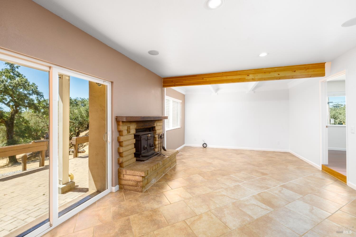1088 Palomino Road Cloverdale, CA 95425 - Photo 17 of 41 a view of an empty room with a fireplace and a window
