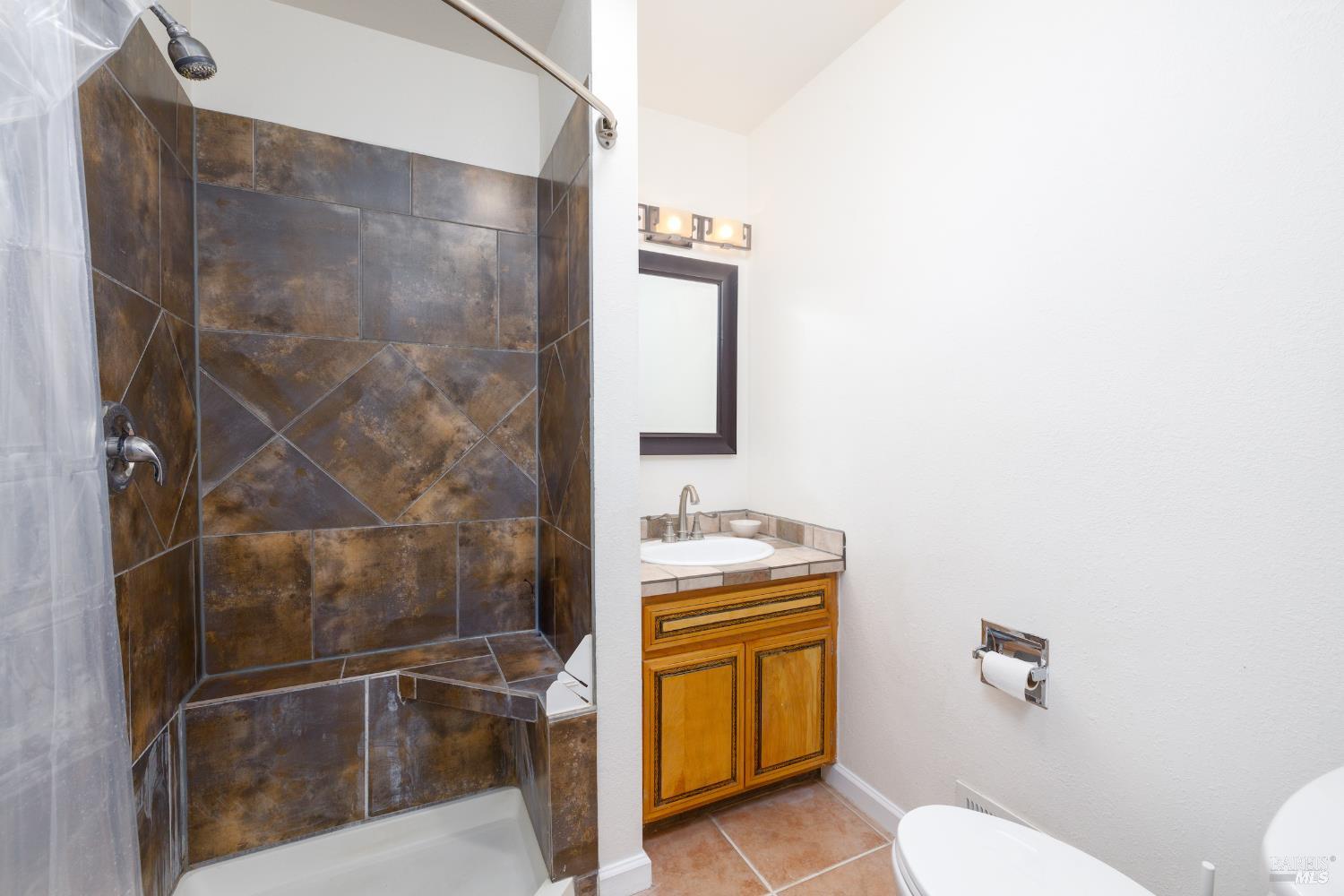 1088 Palomino Road Cloverdale, CA 95425 - Photo 19 of 41 a bathroom with a granite countertop sink mirror vanity and toilet