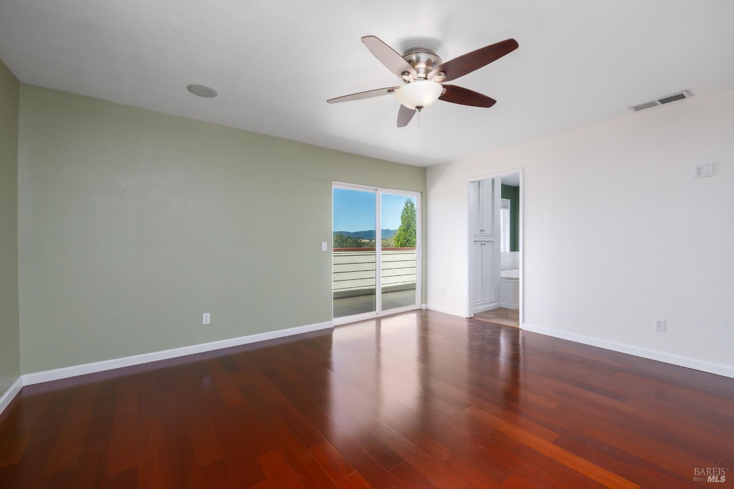 1088 Palomino Road Cloverdale, CA 95425 - Photo 24 of 41 an empty room with wooden floor and windows