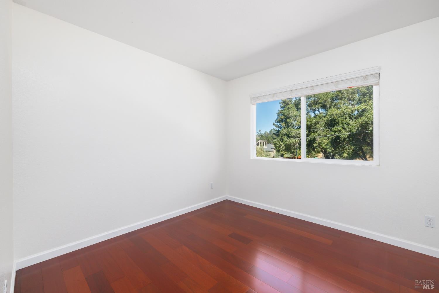 1088 Palomino Road Cloverdale, CA 95425 - Photo 27 of 41 an empty room with wooden floor and windows