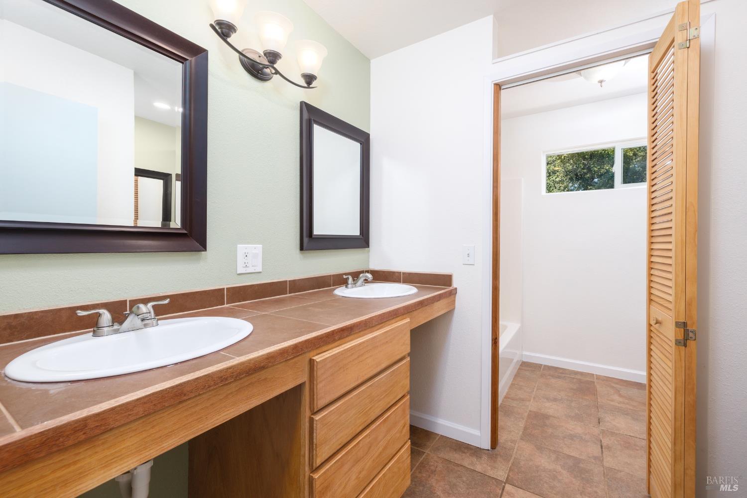 1088 Palomino Road Cloverdale, CA 95425 - Photo 30 of 41 a bathroom with a sink and a mirror