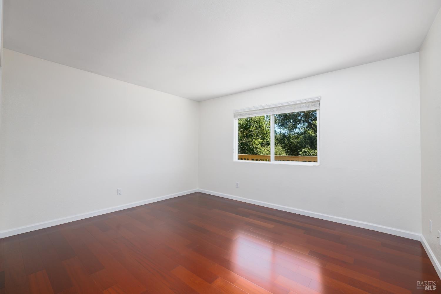 1088 Palomino Road Cloverdale, CA 95425 - Photo 31 of 41 an empty room with wooden floor and window