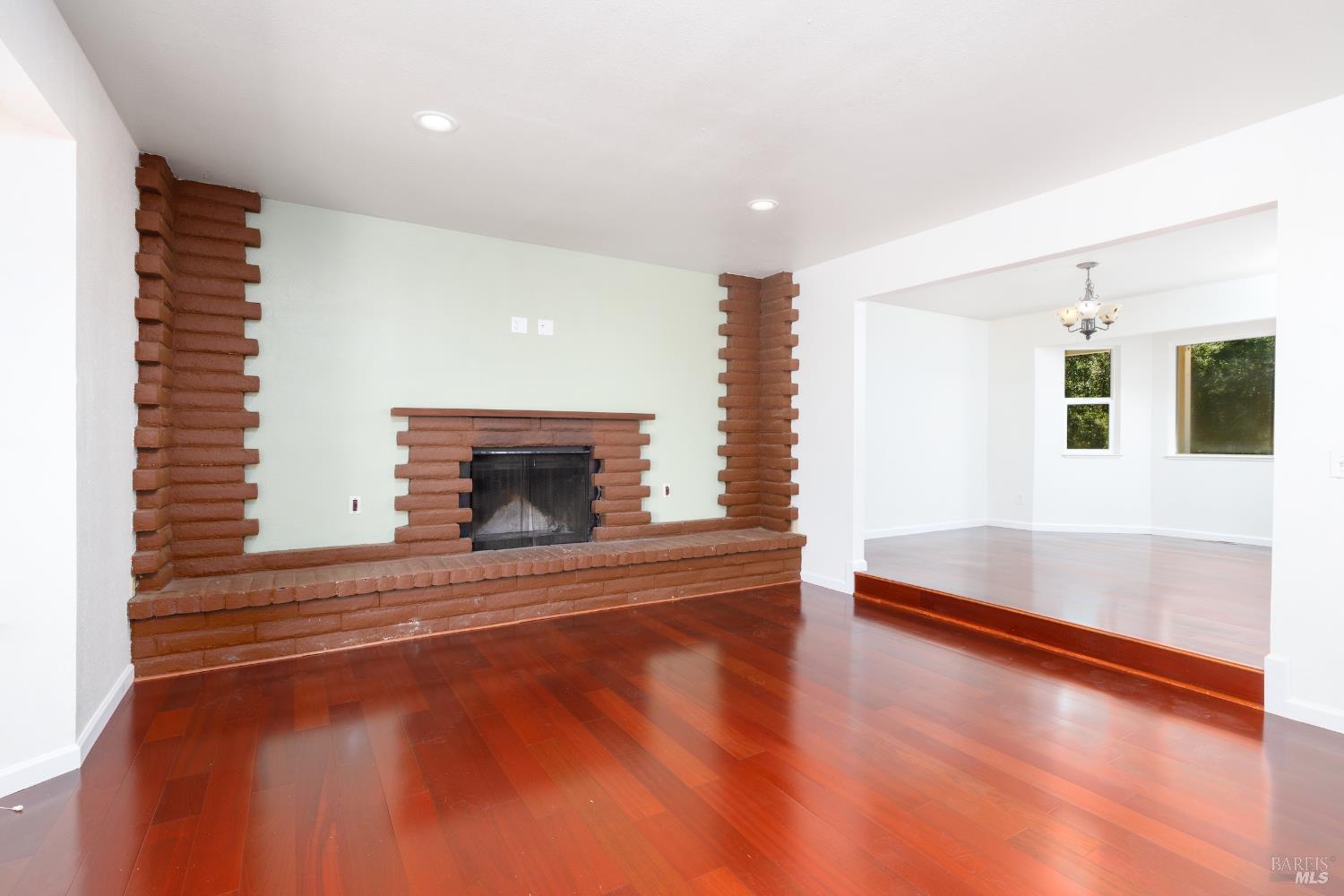 1088 Palomino Road Cloverdale, CA 95425 - Photo 9 of 41 a view of an empty room with wooden floor and a fireplace
