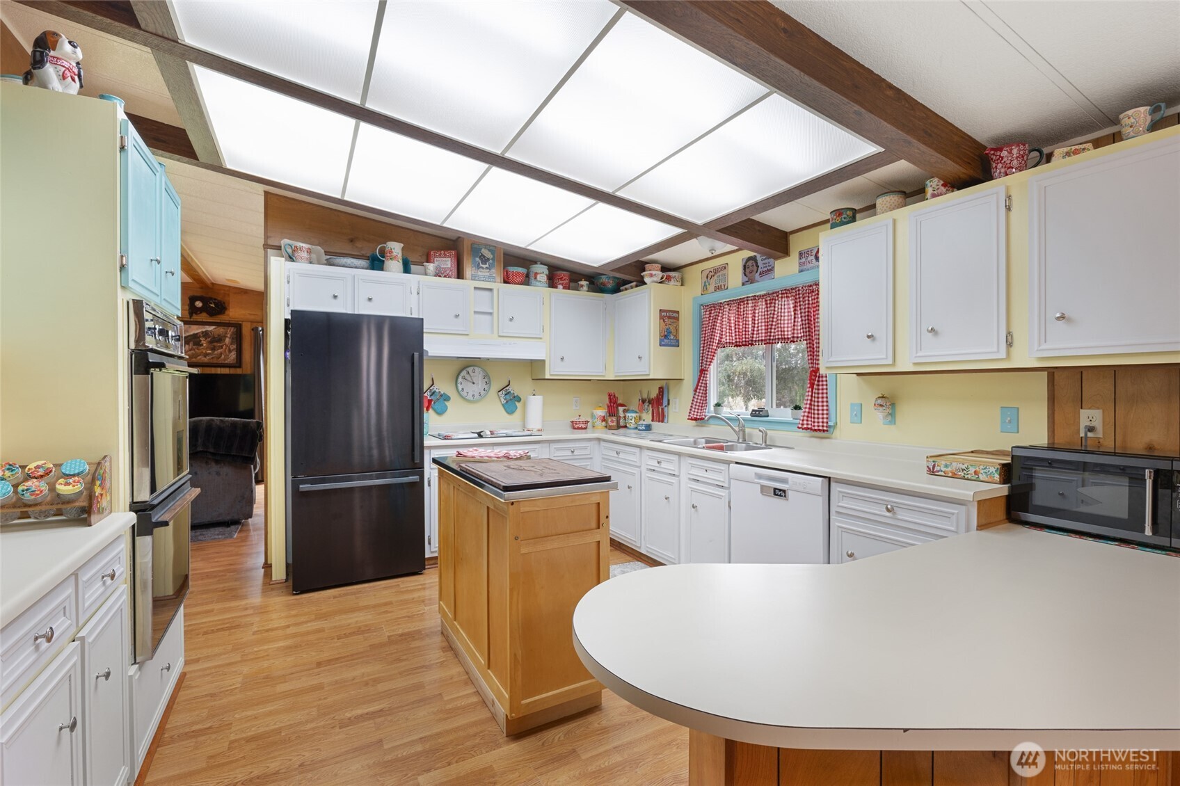 7472 Rd F Southeast, Unit 8 Othello, WA 99344 - Photo 10 of 40 a kitchen with stainless steel appliances granite countertop a sink a stove a refrigerator cabinets and chairs