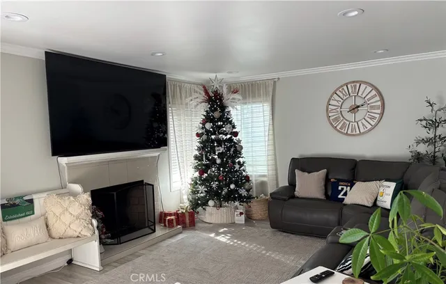 a living room with furniture a flat screen tv and a fireplace