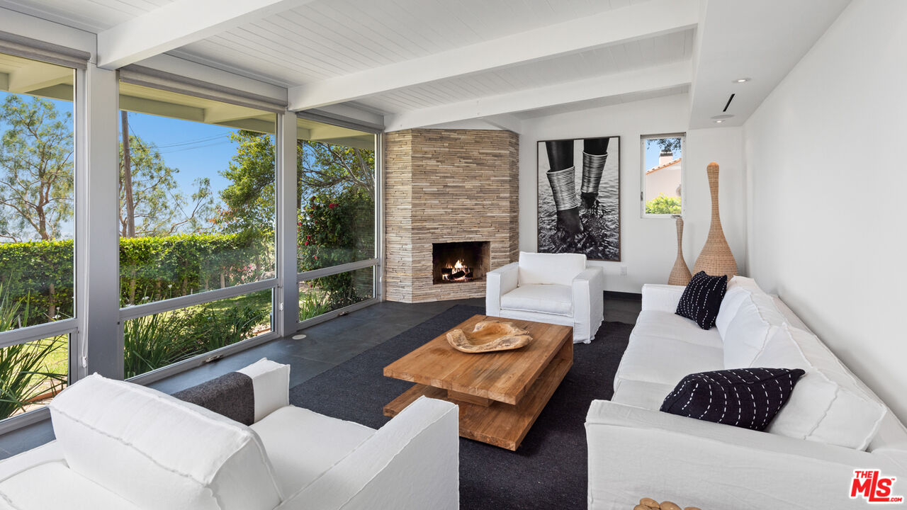 3431 Coast View Drive Malibu, CA 90265 - Photo 11 of 49 a living room with furniture fireplace and a large window