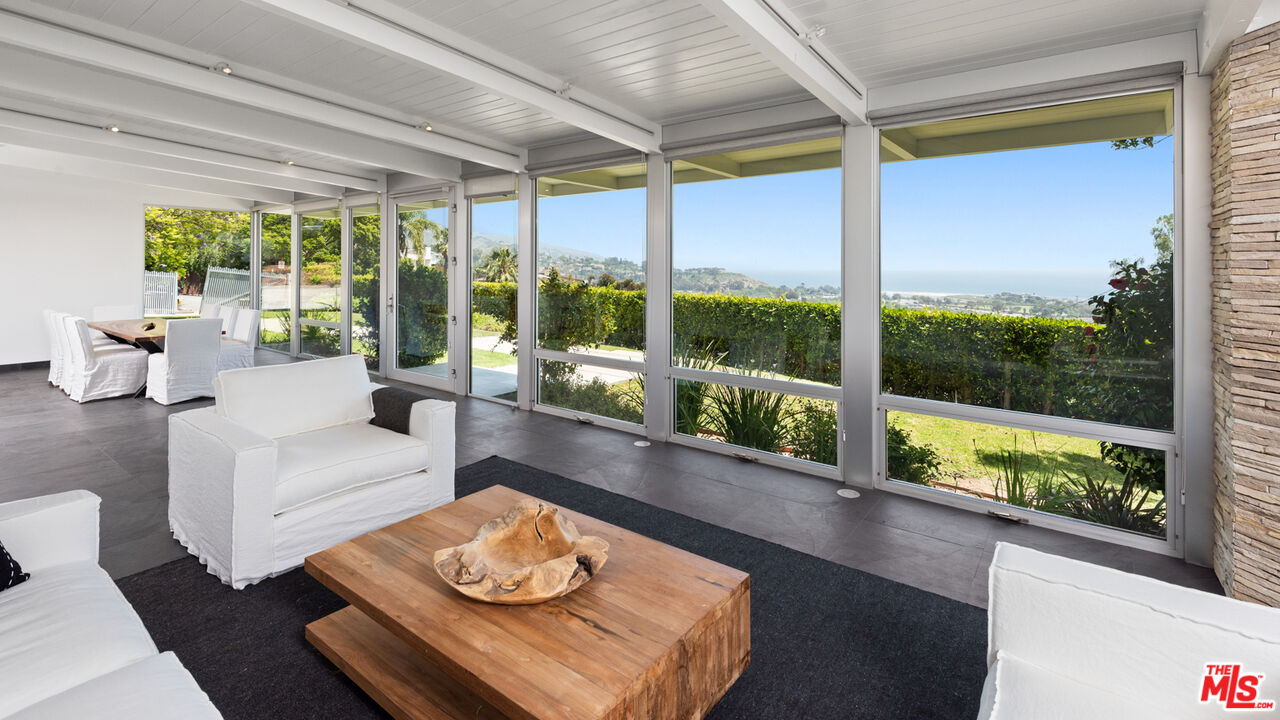 3431 Coast View Drive Malibu, CA 90265 - Photo 12 of 49 a living room with furniture and a large window with garden view