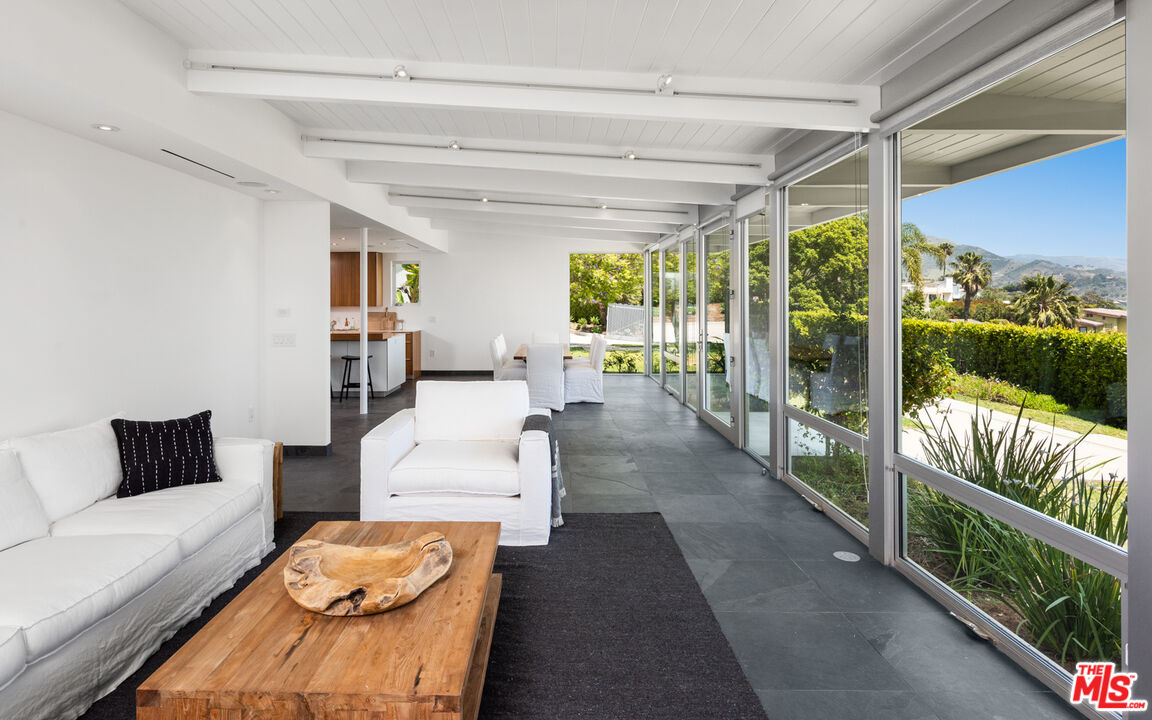 3431 Coast View Drive Malibu, CA 90265 - Photo 13 of 49 a living room with furniture and a floor to ceiling window
