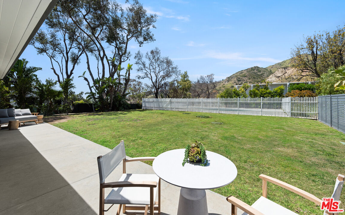 3431 Coast View Drive Malibu, CA 90265 - Photo 22 of 49 a backyard of a house with table and chairs