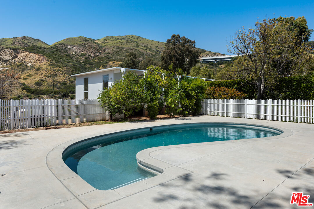 3431 Coast View Drive Malibu, CA 90265 - Photo 23 of 49 a view of a swimming pool with a patio