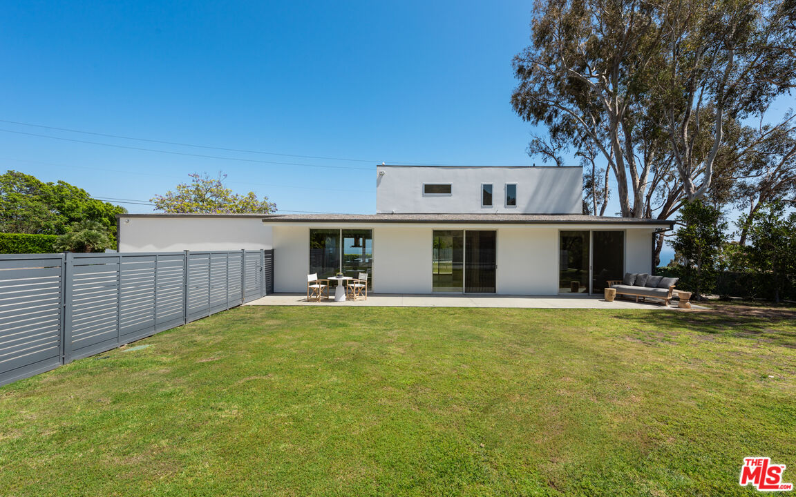 3431 Coast View Drive Malibu, CA 90265 - Photo 24 of 49 a front view of house with yard and trees in the background
